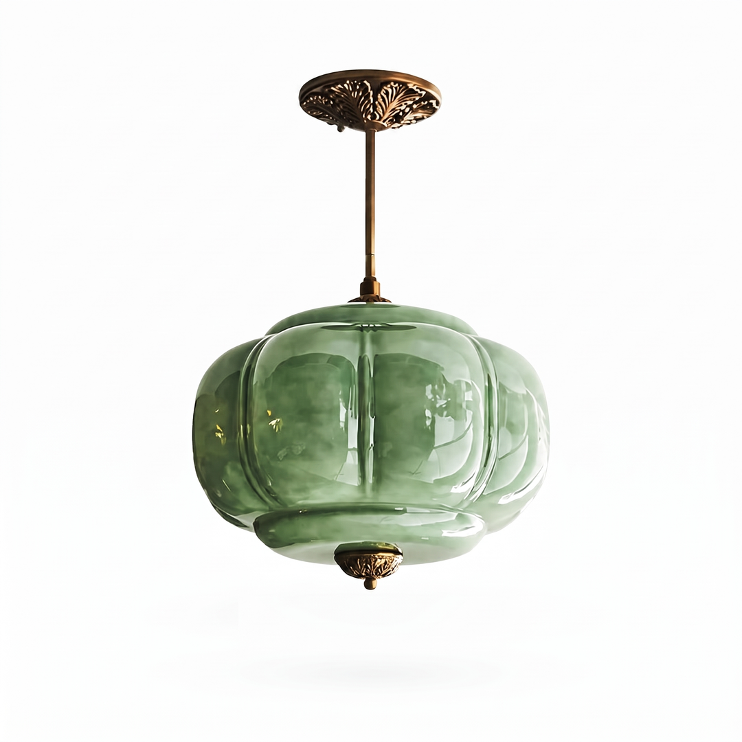 Verella green glass and antique brass pendant light on a white background