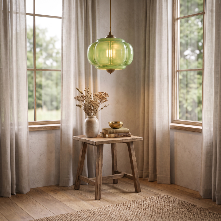 A Verella green glass pendant above a small corner table
